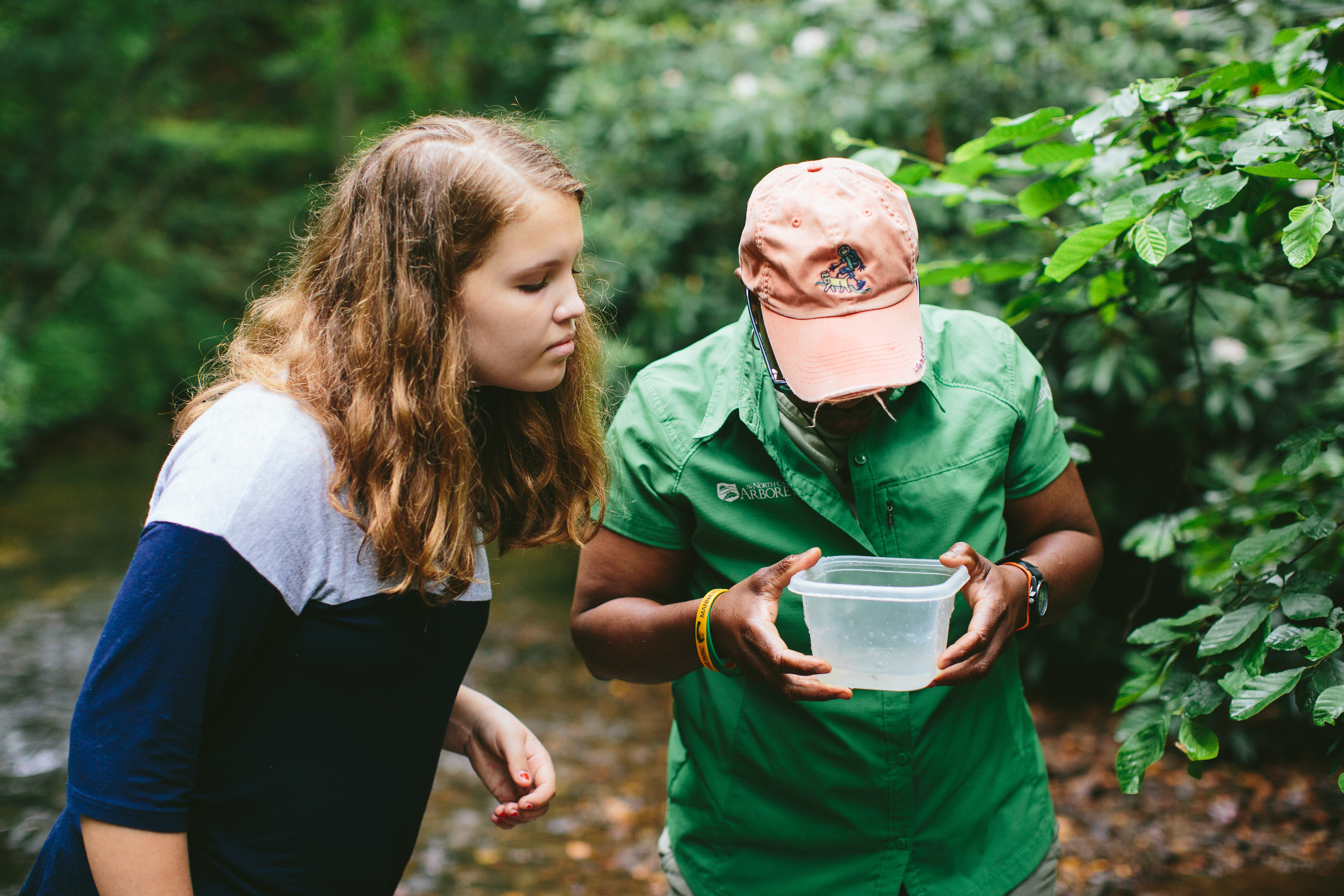 kids looking into a bucket with water