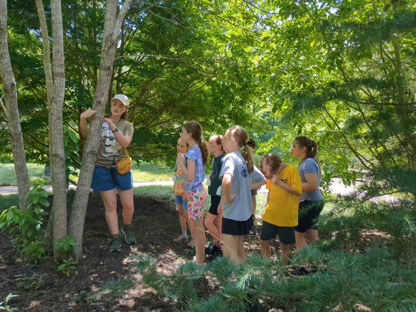 PXL_20250728_165948250.MP_exported_889 (1) Teacher leading students on a nature hike